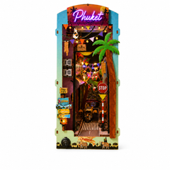 A miniature diorama playset shaped like a building labeled 'Phuket' at the top, featuring a palm tree, colorful string lights, miniature storefront details, and safari-themed decorations, shown on a plain white background.
